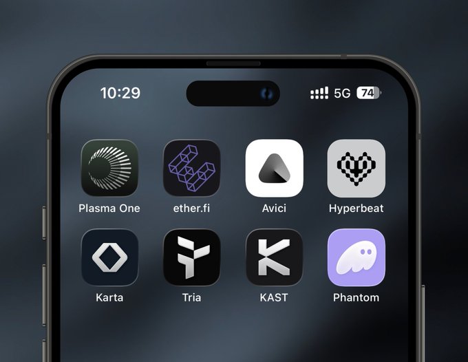The image shows a close-up view of an iPhone screen displaying various app icons for different cryptocurrencies such as Plasma One, EtherFi, Avici, Hyperbeat, Karta, Tria, KAST, and Phantom Cash. The apps are arranged in a grid format on the home screen, with each icon representing a unique cryptocurrency offering features or functionalities related to digital currency management or trading. The image also includes text that provides information about these apps, such as their names and the total combined volume of all the apps.
