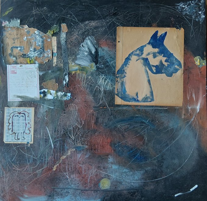 An abstract mixed-media artwork featuring collage elements, including a prominent blue silhouette of a dog/wolf on cardboard, with various papers and textured paint layers.