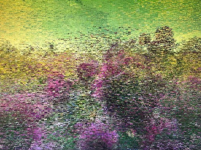 A vibrant glitch-style digital artwork titled "LOWREZ122" featuring a pixelated, low-resolution landscape blending green, yellow, and purple hues, reflecting its abstract and glitch art aesthetic being offered as a limited edition NFT on the Tezos blockchain.