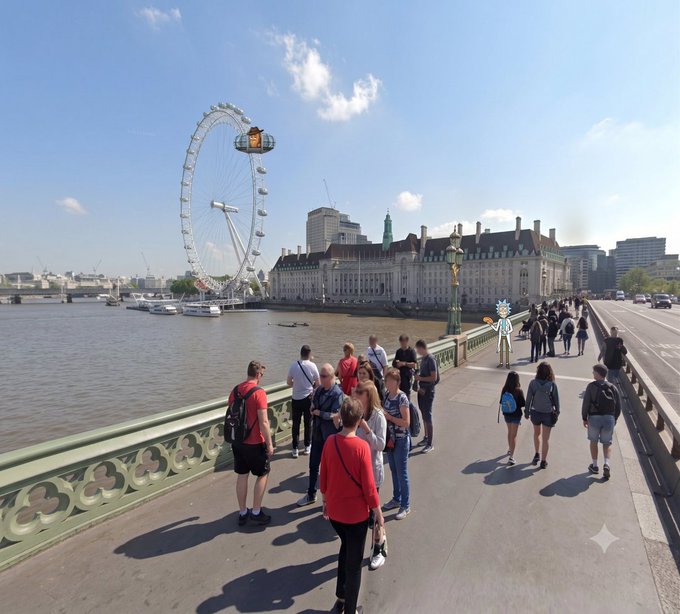 Outdoor daytime photo of pedestrians walking across a bridge in London with the London Eye Ferris wheel and County Hall visible across the River Thames.