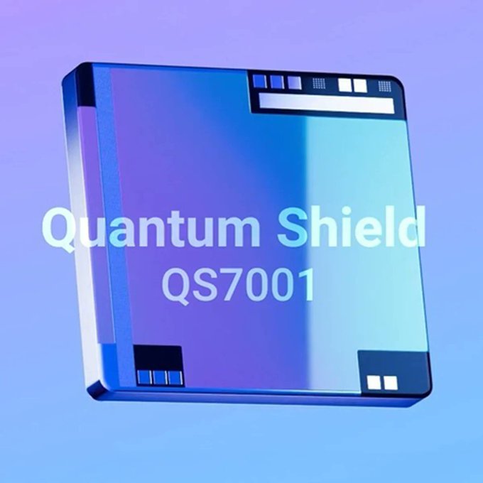 A 3D-rendered promotional image of a blue translucent square chip labeled 'Quantum Shield QS7001' against a purple-blue gradient background.