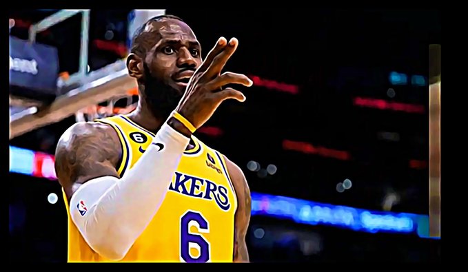 NBA player LeBron James in his yellow Lakers jersey number 6 gestures with his hand on the court, with the number 6 sponsor patch visible on his chest.