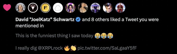 A Twitter/X notification showing David "JoelKatz" Schwartz and 8 others liked a tweet that mentions the user, which reads "This is the funniest thing I saw today 😂😂😂 I really dig @XRPLrock 🔥👏"