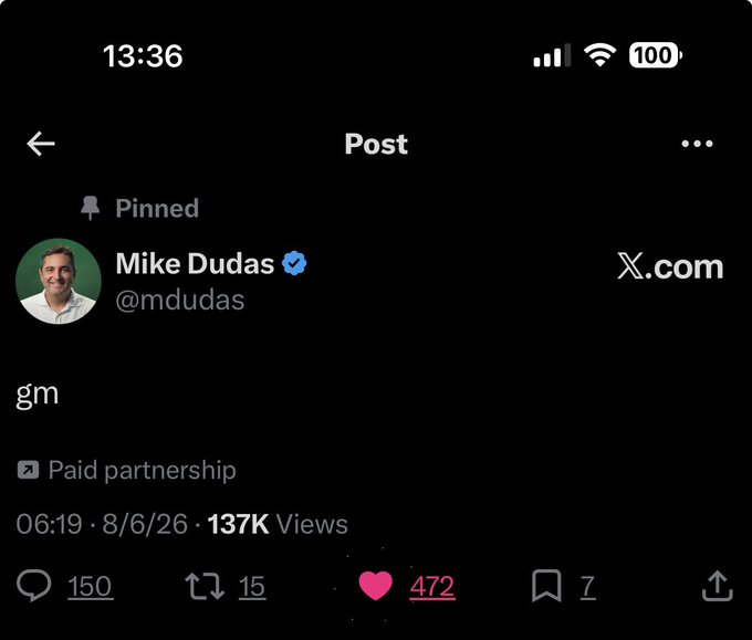 A screenshot of an X (Twitter) post by Mike Dudas (@mdudas) that says 'gm' with 137K views, 472 likes, and marked as a paid partnership.