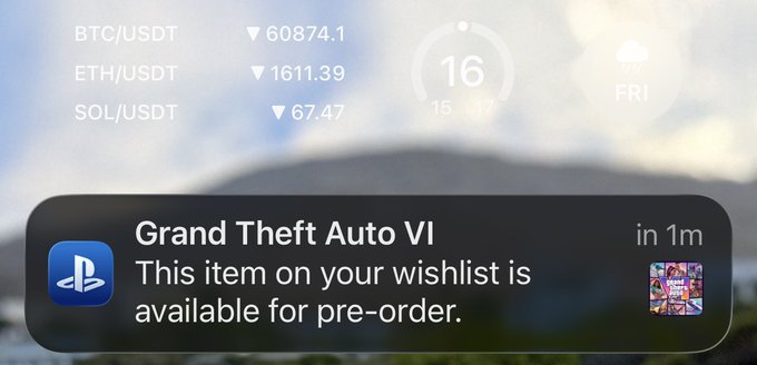The image shows a cellphone screen with an email about Grand Theft Auto V. The text of the message says "Best notification of June Bitcoin/USDT can go wherever it wants, I am paying those shekels to buy GTA VI instead of buying the dip". This is related to the post because someone has purchased a new game using Bitcoin and used its exchange rate to purchase video game copies on PlayStation. The person who received the message seems to be congratulating them on their purchase or asking about their experience with the Bitcoin/USDT exchange rate in relation to purchasing games from PlayStation.