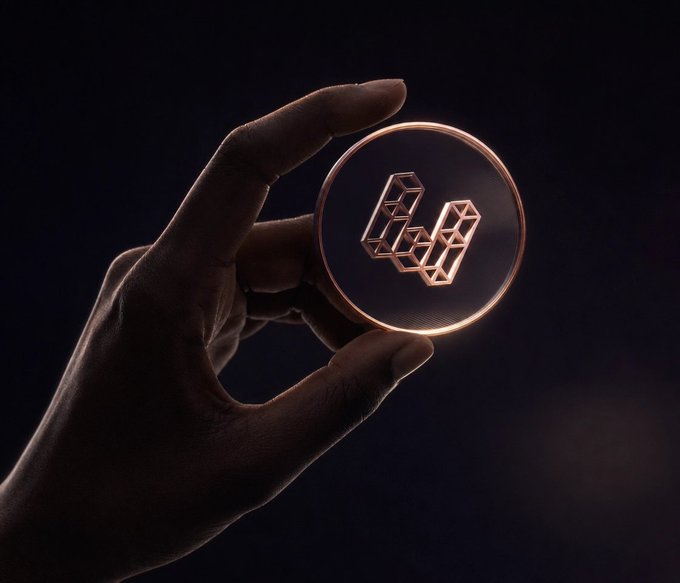 A silhouetted hand holds up a glowing, transparent circular medallion featuring a stylized "E" logo made of interconnected geometric cubes, representing EtherFi's branded crypto card. The luminous emblem visually reinforces the post's praise of EtherFi as a standout option in the crypto card market.