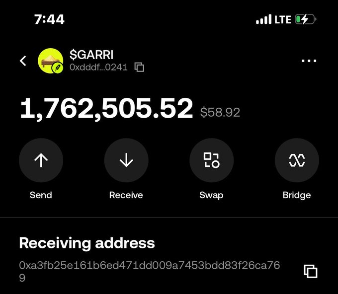 A mobile screenshot of a crypto wallet showing a balance of 1,762,505.52 $GARRI tokens ($58.92) with options to Send, Receive, Swap, and Bridge.