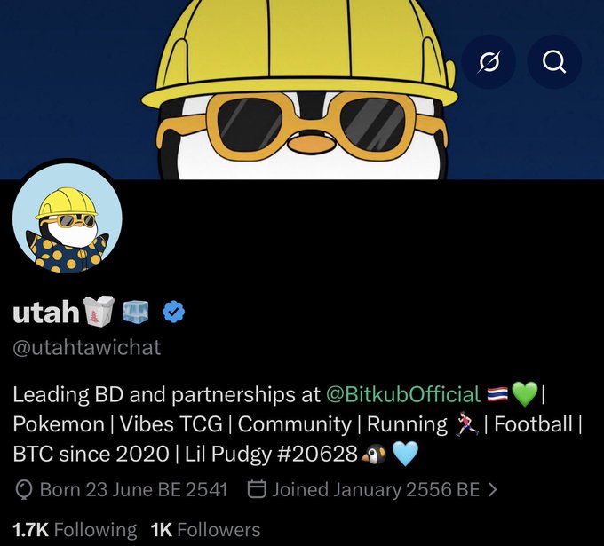 A Twitter/X profile page for 'utah' (@utahtawichat) featuring a penguin mascot wearing a yellow hard hat and sunglasses, with a bio mentioning BitkubOfficial.