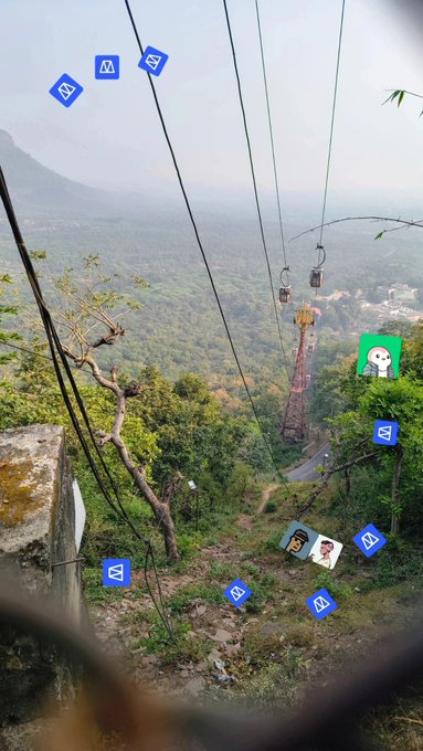 The image shows a view of a cable car system with multiple cables, wires, and poles. There are several small squares or icons scattered throughout the scene, possibly representing different elements such as people's names or logos. The caption reads "Good Morning Everyone!! Does CT forgot that @Polymarket rewarding creators..". This message is related to the image because it appears to be a social media post featuring an aerial view of the cable car system and its surroundings.