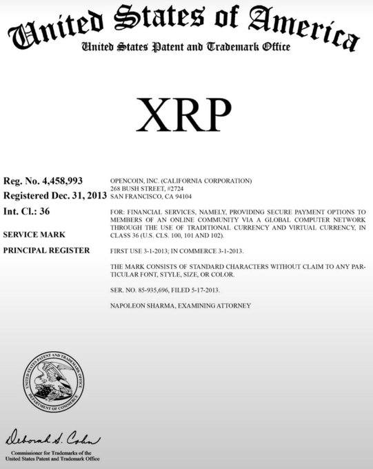 The image shows a U.S. Patent and Trademark Office registration certificate for the "XRP" service mark, registered to OpenCoin, Inc. (California Corporation) on December 31, 2013, with Registration No. 4,458,993 in International Class 36 for financial services related to secure payment options using traditional and virtual currency. This document substantiates the accompanying post's claim that Ripple officially trademarked the "XRP" ticker with the USPTO.
