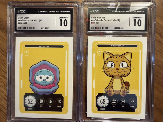 Two CGC-graded trading cards (Gem Mint 10) from the Veefriends Series 2 (2022) — 'Calm Clam' by zzerocool and 'Boss Bobcat' by zzerocool — displayed in clear protective slabs.