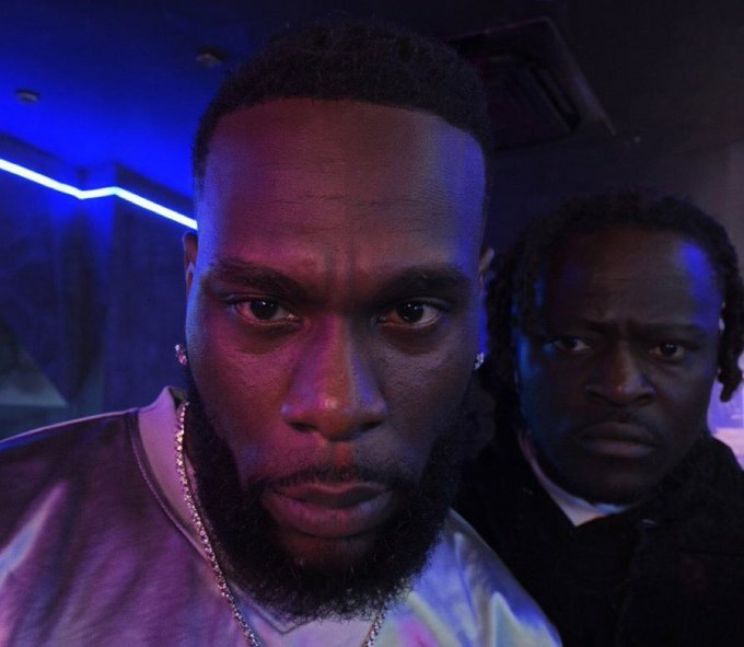 Two men pose intensely for a selfie in a dimly lit space with blue neon lighting, their serious expressions and close framing creating a dramatic, confrontational mood that mirrors the post's message about devoted followers of #ICP who remain locked in, watching closely despite any criticism.
