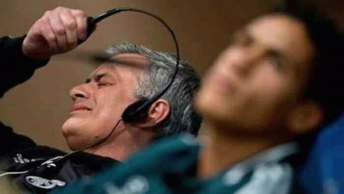 A man in a headset contorts his face in apparent frustration or anguish, with another man blurred in the background, visually capturing the emotional chaos that can accompany the volatile pursuit of becoming a millionaire from a single Solana investment.