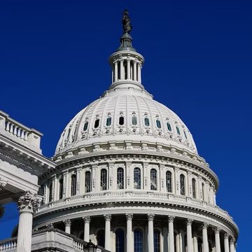 The image shows the iconic white dome of the United States Capitol building against a vivid blue sky, symbolizing the legislative activity in Washington. This visual ties directly to the post's mention of the CLARITY Act, as the Capitol represents the federal government where regulatory decisions regarding XRP and the crypto industry are being made.