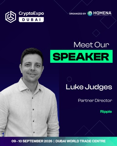 A promotional graphic for Crypto Expo Dubai announces Luke Judges, Partner Director at Ripple, as a featured speaker for the September 9-10, 2026 event at Dubai World Trade Centre, organized by HQMENA. The design features a black-and-white headshot of Judges alongside bold "Meet Our SPEAKER" text on a dark purple background, visually supporting the post's mention of Ripple's executive joining the lineup.