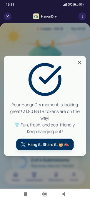 A mobile app screen for 'HangnDry' showing a confirmation popup that reads 'Your HangnDry moment is looking great! 31.80 B3TR tokens are on the way! Fun, fresh, and eco-friendly. Keep hanging out!' with a button to 'Hang it. Share it.'