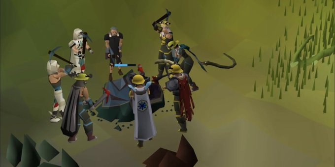 A screenshot from the game Old School RuneScape showing a group of player characters gathered around a defeated boss monster on a green landscape.
