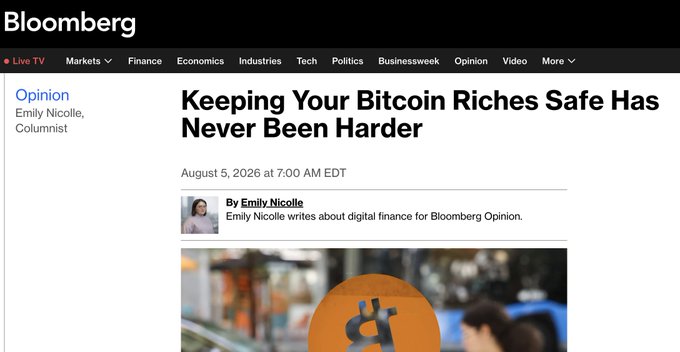 Screenshot shows a Bloomberg Opinion article titled "Keeping Your Bitcoin Riches Safe Has Never Been Harder" by Emily Nicolle, dated August 5, 2026, referencing the reported $100M+ theft from hardware wallet users due to compromised seed phrases.