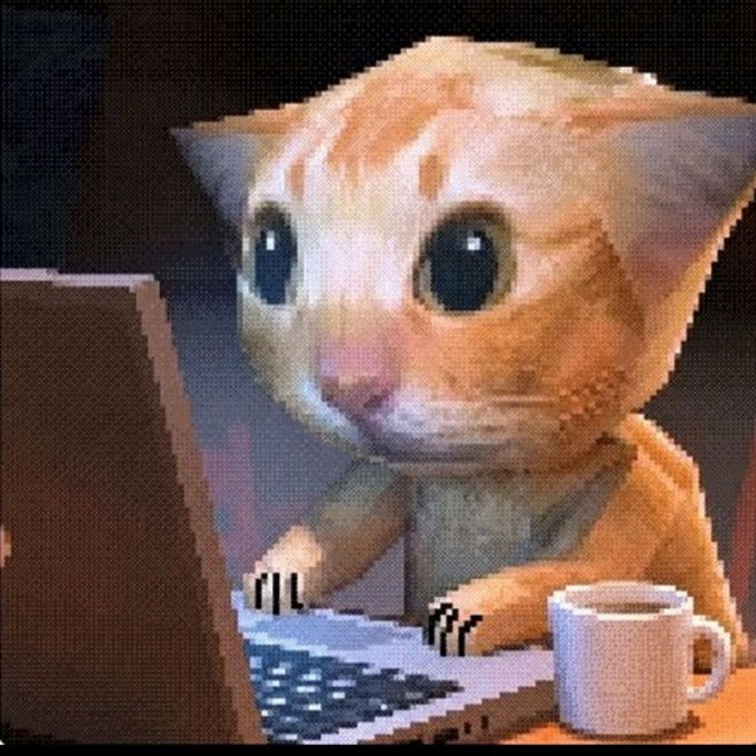 A pixelated orange cat sitting at a laptop with a coffee mug nearby.