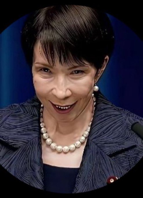 A portrait of an East Asian woman with short dark hair, wearing a pearl necklace and dark blue textured jacket, smiling against a dark blue background.