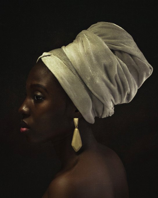 A profile portrait of a woman with dark skin wearing an olive-green velvet head wrap and a large gold geometric earring, set against a black background.