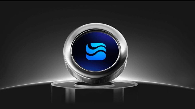 The image features a silver button with a blue logo that says "River4Fun" on it. The button is placed on top of a black surface against a dark background, which makes it stand out prominently. The text in the image reads "@River4fun", indicating that the button is associated with the River4Fun account.