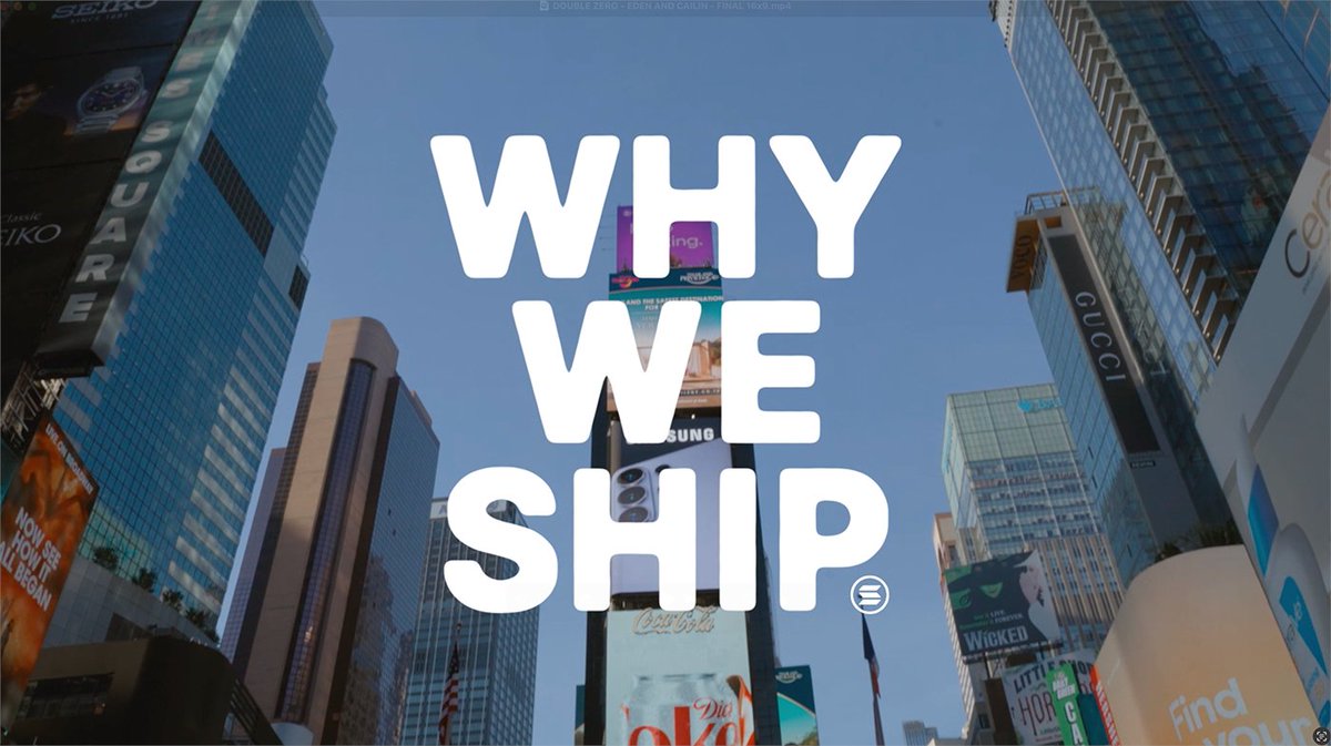 Large white text reading "WHY WE SHIP" is overlaid on a low-angle cityscape of Times Square, with visible billboards for Seiko, Square, Gucci, Coca-Cola, Diet Coke, and Samsung adorning the surrounding skyscrapers. The image visually echoes the post's theme by framing the "non-technical developers" narrative against the iconic backdrop of NYC advertising and storytelling culture.