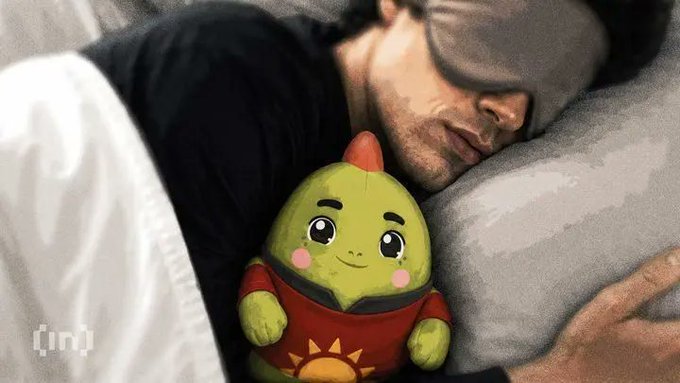 The image features a man sleeping next to his green stuffed animal, which has a sun design on its shirt. The man appears to be wearing eye glasses while he sleeps with the toy. There are also some text elements present in the image that read "Who else is joining the @sleepagotchi Creator Campaign on @NucleusCodes? I’m already in - climbing the leaderboard one post at a time Looking to connect with others who are: ✦ Active in the Sleepagotchi community ✦ Bullish on Sleep-to-Earn & health data in Web3".