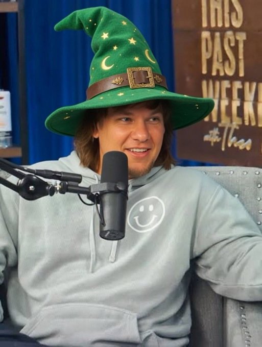 iced coffee and a green witch hat with gold accents are featured on the cover of "This Week at The Times".