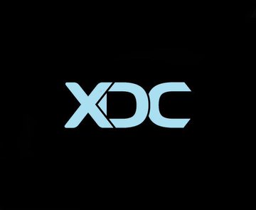 The XDC Network logo is displayed in light blue against a black background, featuring stylized letters with a distinctive design where the 'X' and 'D' share a common vertical element.