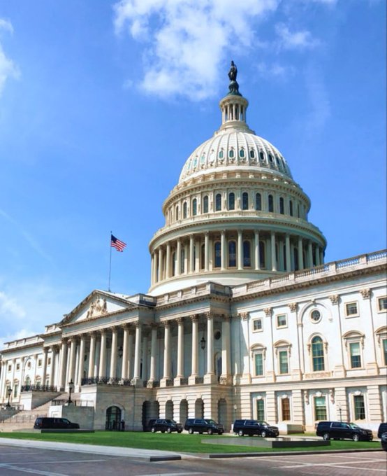 The image shows the U.S. Capitol Building, the seat of the U.S. Congress where the House Financial Services Committee will convene to review legislation on September 16 establishing a Strategic Bitcoin Reserve and a separate digital asset reserve at the U.S. Treasury. The American flag flies prominently beside the iconic white dome, symbolizing the federal government's central role in shaping future cryptocurrency policy.