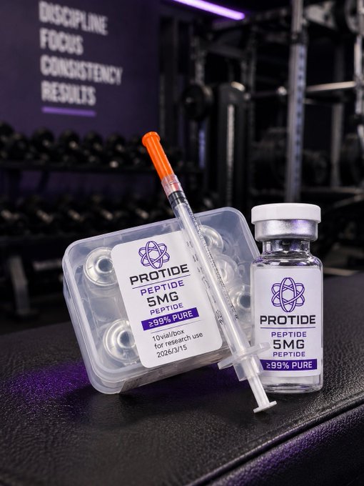 The image features two vials of medicine, one larger and one smaller, sitting on top of a black surface. The larger vial has an orange needle attached to it, while the smaller vial contains a pill or tablet. The background is blurred, but there are some dumbbells visible in the scene. The text "PEP TALES" can be seen, which might be related to the medicine being used for muscle building and strength training purposes.
