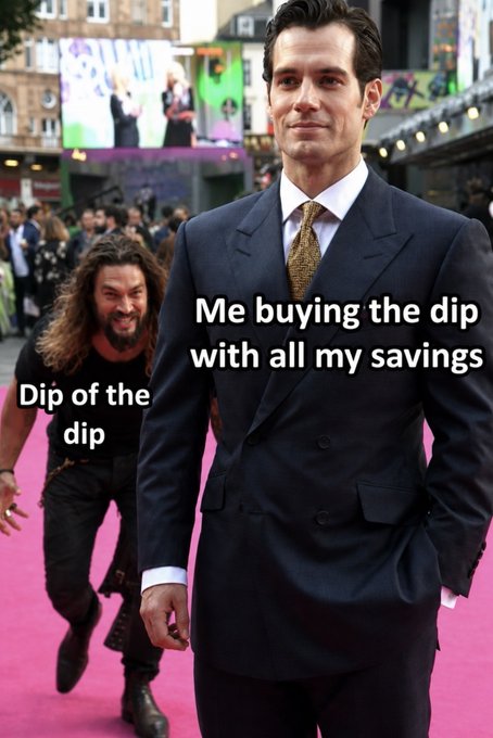 A meme using a photo of actors Henry Cavill and Jason Momoa shows Cavill in a suit walking confidently with the text 'Me buying the dip with all my savings', while Momoa runs behind him labeled 'Dip of the dip'.