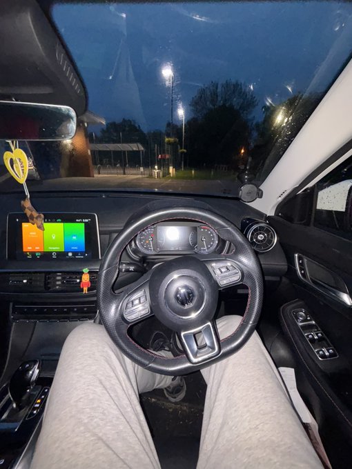 The dashboard of a Volkswagen car at dusk, with the infotainment screen displaying app icons. The view from the driver's seat captures a quiet parking area under streetlights, fitting the post's "Sweet dreams" farewell to web 3.