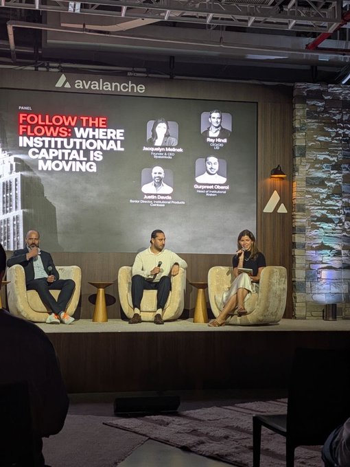 A panel discussion at an Avalanche event titled 'FOLLOW THE FLOWS: WHERE INSTITUTIONAL CAPITAL IS MOVING,' featuring speakers Jacquelyn Melinek, Roy Hindl, Justin Dillion, and Gurpreet Chand on stage.