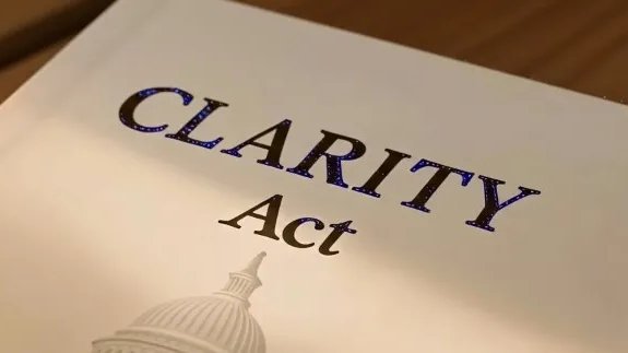 A printed document titled "CLARITY Act" is displayed with the U.S. Capitol dome visible at the bottom, symbolizing federal legislation. The image visually reinforces the post about Citibank urging the Senate to pass this cryptocurrency regulatory bill.