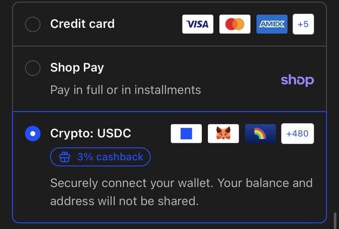 The image shows a display screen of a website, possibly a mobile shopping application or website for online shopping with credit cards, displaying payment options such as USDC (UDP Cashback). The screen also has a button labeled "Crypto". In the bottom left corner of the image, there is text that reads: " securely connect your wallet. Your balance and address will not be shared". This text suggests that the user should ensure they only share their payment information with trusted parties like the website or mobile app displaying these payment options.