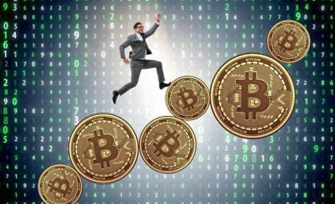 Stock photo showing a businessman jumping over large Bitcoin coins against a background of digital code.