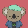 A cartoon koala wearing a teal beret and a blue jacket with 'KS' on it, set against a solid red background.