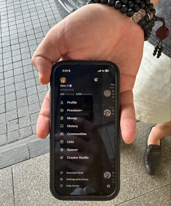 A hand holds a smartphone displaying an X (formerly Twitter) profile menu for user "Glen" (@itsglennott) with 492 Following and 3,700 Followers, showing navigation options like Profile, Premium+, Money, and Communities.

The image appears to show someone showcasing a crypto/tech-related X profile, possibly connected to the Kraken ecosystem mentioned in the caption, serving as visual "proof" of following or researching the project described.