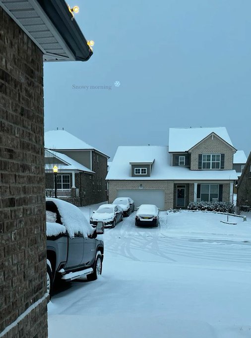 The image shows a snowy driveway outside of a house with snow-covered cars parked along it. The sky above appears to be cloudy, creating a serene winter scene. In the background, there are two houses visible, one closer to the viewer and another further away. A car is also present in the foreground on the right side of the image. 

The post features an image of a snow-covered driveway with cars parked along it. The text "Can I get a GM JUne is promising with @quipnetwork @wallchain @3look" suggests that there might be a connection between the snowy scene and the car's model or brand, possibly related to the winter season or the location of the house.