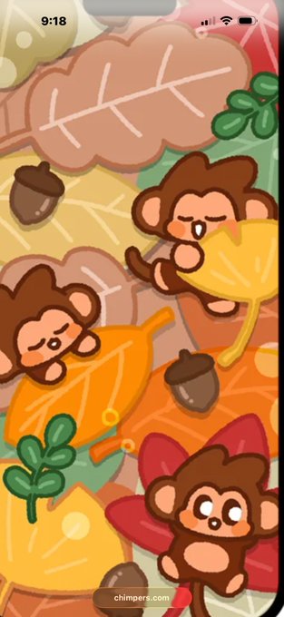 A colorful wallpaper featuring cute cartoon monkeys playing with autumn leaves and acorns, with the time '9:18' visible at the top.