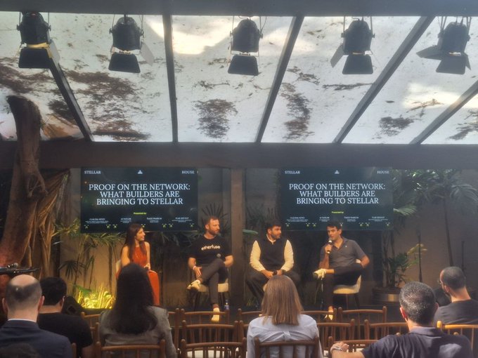 A panel discussion titled 'PROOF ON THE NETWORK: WHAT BUILDERS ARE BRINGING TO STELLAR' hosted by Stellar and House, with four panelists seated on stage before an audience under a skylight.