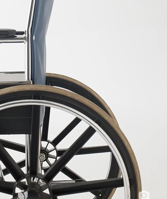 A close-up photograph of a black wheelchair's large spoked rear wheel with a tan-colored tire, set against a plain white background, evoking the "$CRT" (critical race theory) conversation referenced in the September 2026 post.