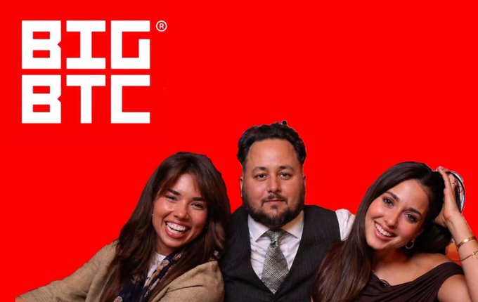 A promotional image with a red background featuring the white 'BIG BTC' logo in the top left corner, and three smiling people (two women and a man in formal attire) posing together at the bottom.