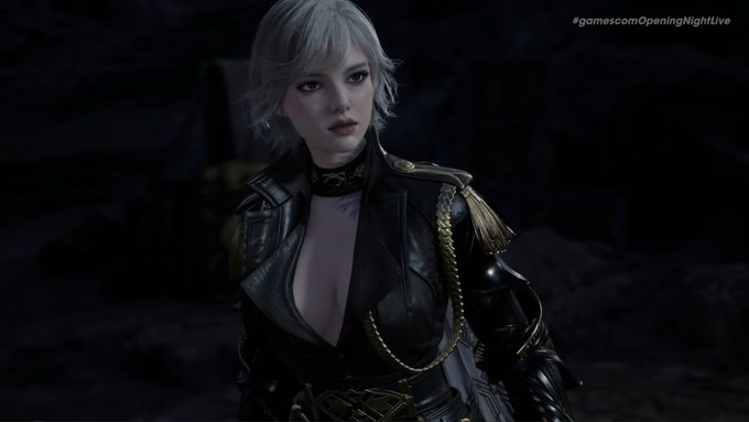 A pale, silver-haired female character in an ornate black and gold leather outfit with shoulder armor stares forward in a dark setting, likely a cinematic cutscene. The hashtag "#gamescomOpeningNightLive" appears in the upper right corner, suggesting this is a reveal for the game "Aion" showcased at the gaming event.