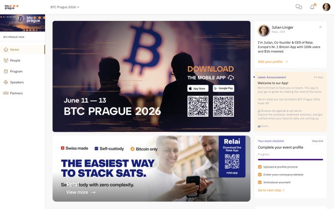 The image shows an advertisement that promotes Bitcoin Prague at its upcoming event. It features an image of people with their backs turned towards a large Bitcoin logo displayed below it. Below the Bitcoin logo, there's text suggesting that attendees can download the mobile app or get more information about the event by clicking on certain buttons. The post mentions that this year's event will be the biggest one yet and emphasizes the exciting nature of the Bitcoin Prague.