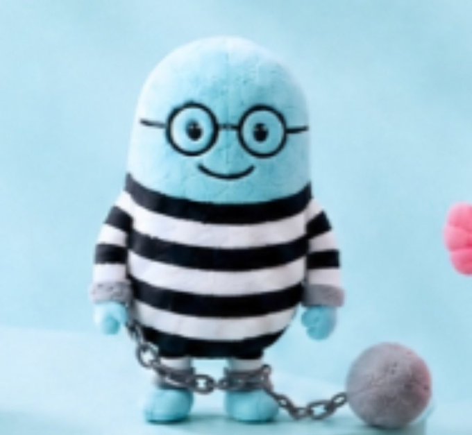The image features a blue stuffed animal doll with glasses standing next to a chain ball. The doll has a round head and a pair of glasses, giving him an intelligent and scholarly appearance. He appears to be wearing a prison uniform, which adds to his overall look. The chain ball is placed on the right side of the doll's body, creating a sense of balance in the composition. The post about the blue doll being like you @cz_binance seems to be referring to the unique combination of the doll's features and the chain ball, emphasizing their connection as if they were made for each other.