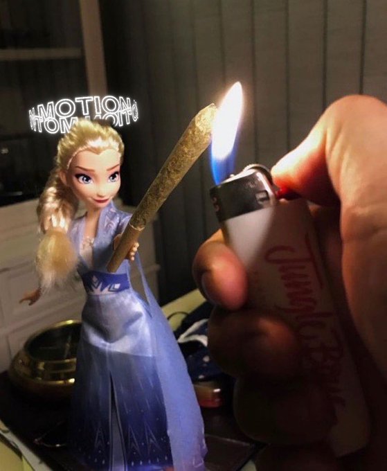 An Elsa doll from Frozen is depicted holding a blunt/joint, with a hand using a lighter to light it, and reversed 'EMOTION' text visible in the background.