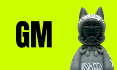 The image features a gray LEGO-style minifigure with cat ears and a beaded necklace alongside bold black "GM" (Good Morning) text on a bright neon green background, conveying a cheerful crypto/NFT community greeting that aligns with the post's collaborative announcement.